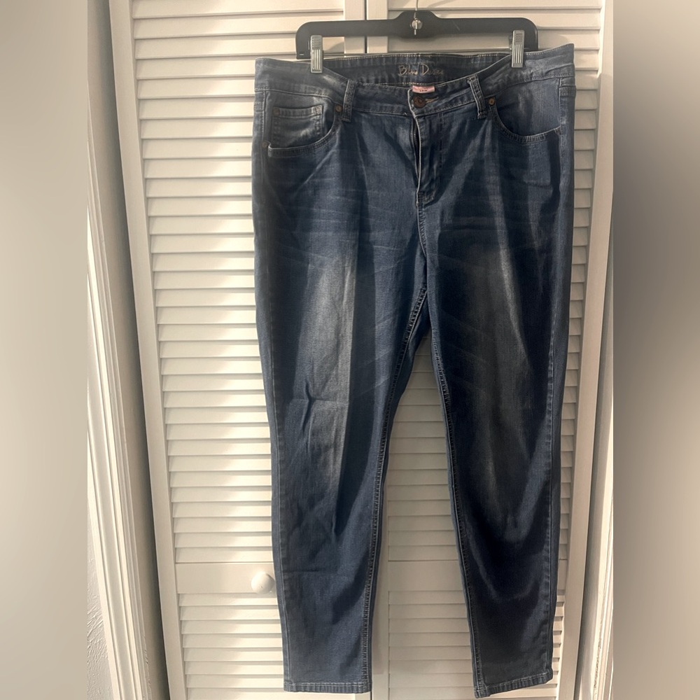 Plus size, dark-blue jeans with intentional fading on knees and bum.